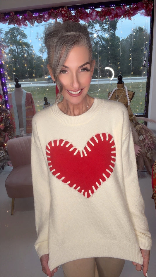 Fuzzy knit sweater with a red heart graphic and white stitch